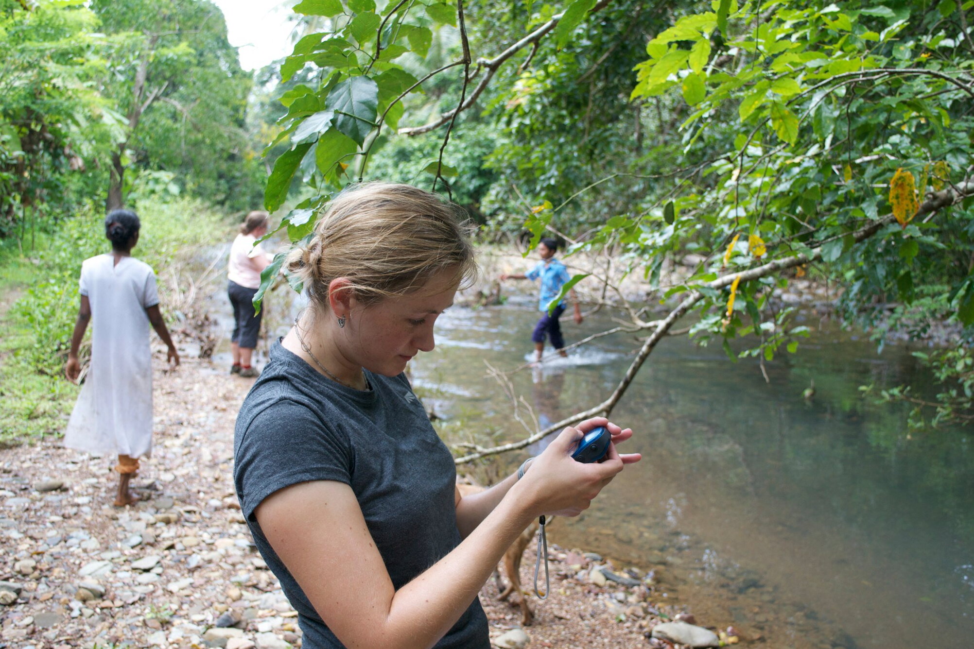A student looking at a tool in their hands.